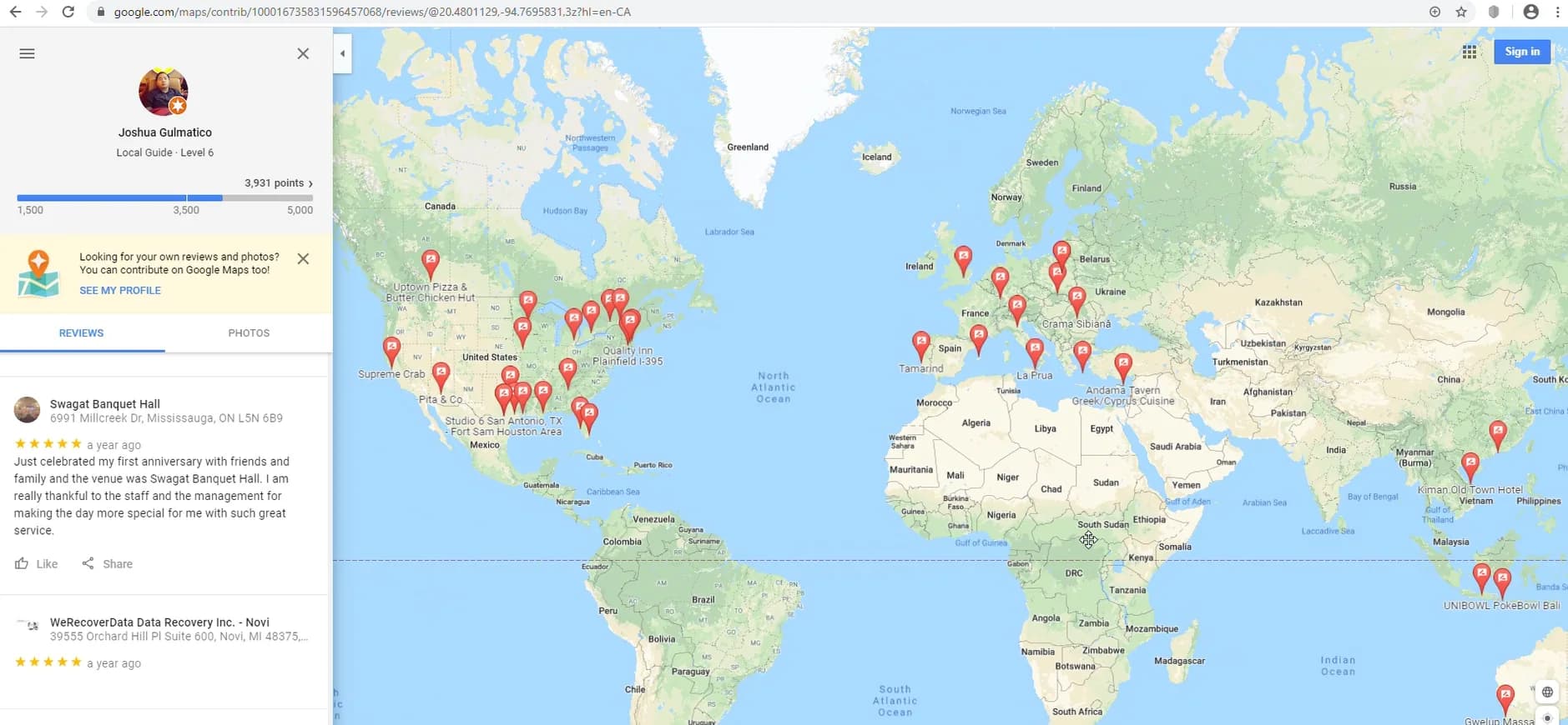 Google Maps contributor page for a Local Guide account named Joshua Gulmatico, Level 6, 3,931 points, with a world map of review pins across several continents and a visible 5-star review of WeRecoverData Data Recovery Inc. - Novi displayed as a year ago, with no review text shown.
