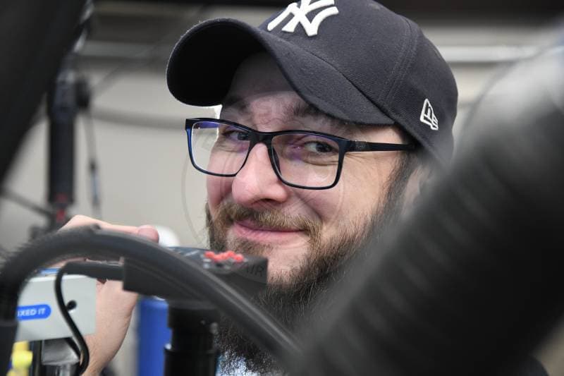 Technician performing MacBook liquid damage repair