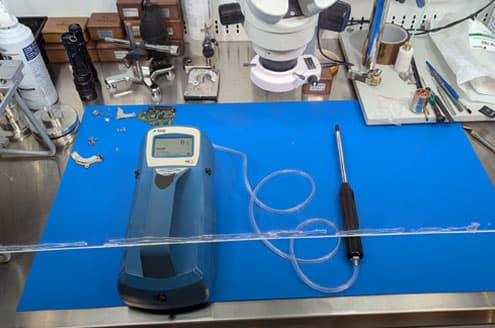 TSI P-Trak particle counter on the bench with laminar sheet
